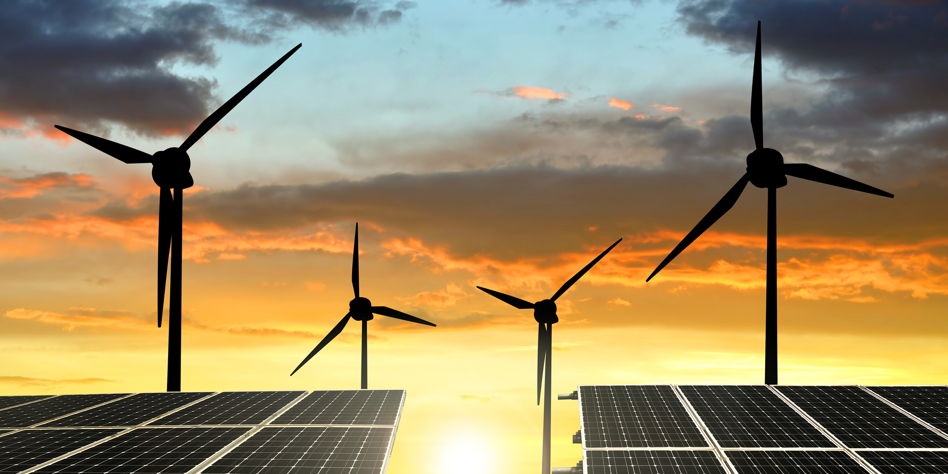 solar energy panels and wind turbines at sunset