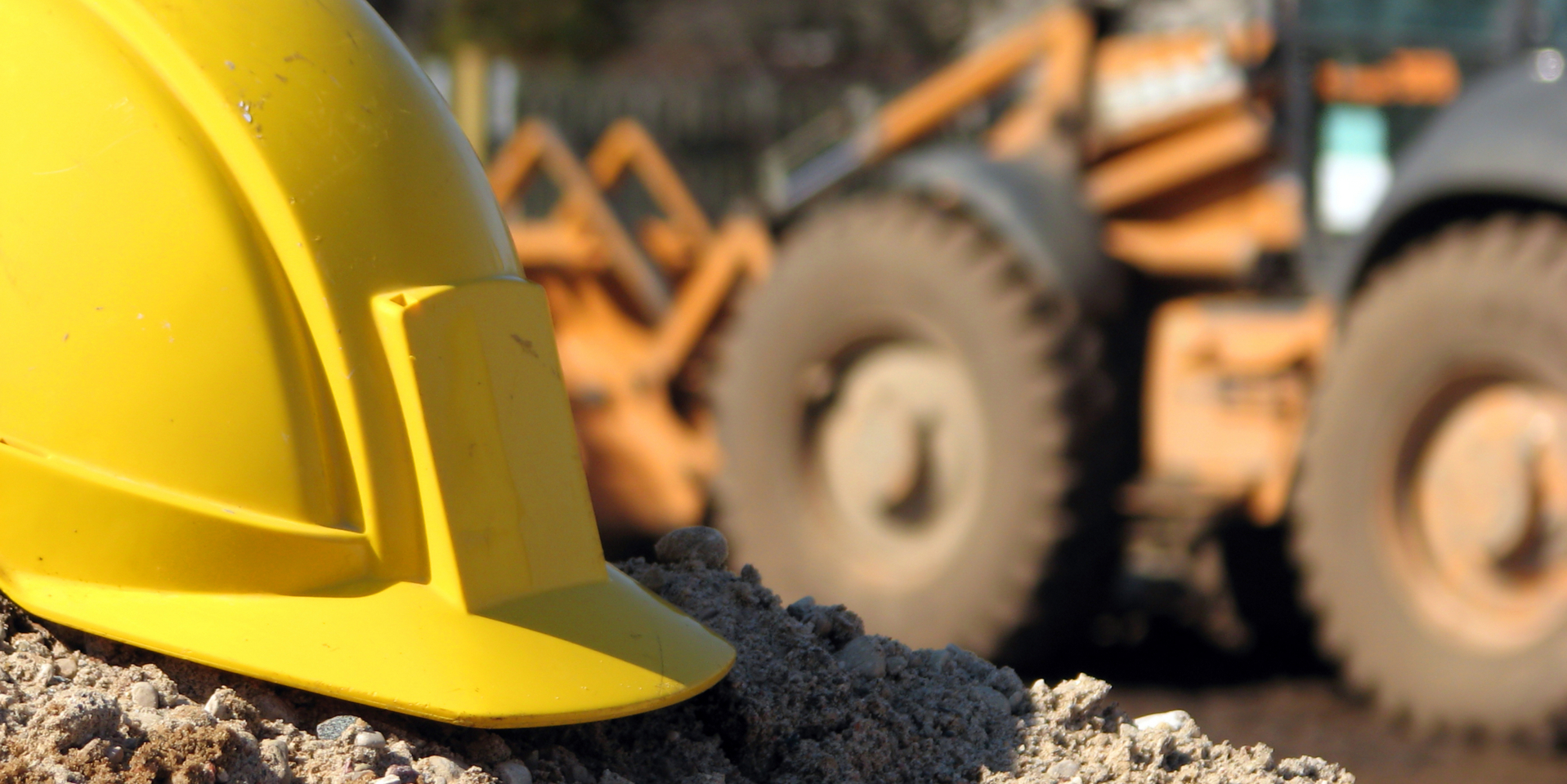 Close angle of yellow hard hat at construction site.
