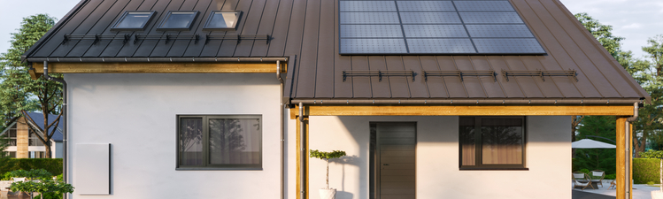 Modern house with solar panels and wall battery for energy storage.
