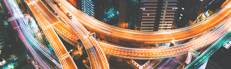 Aerial view of a massive highway intersection at night in Shinjuku, Tokyo, Japan