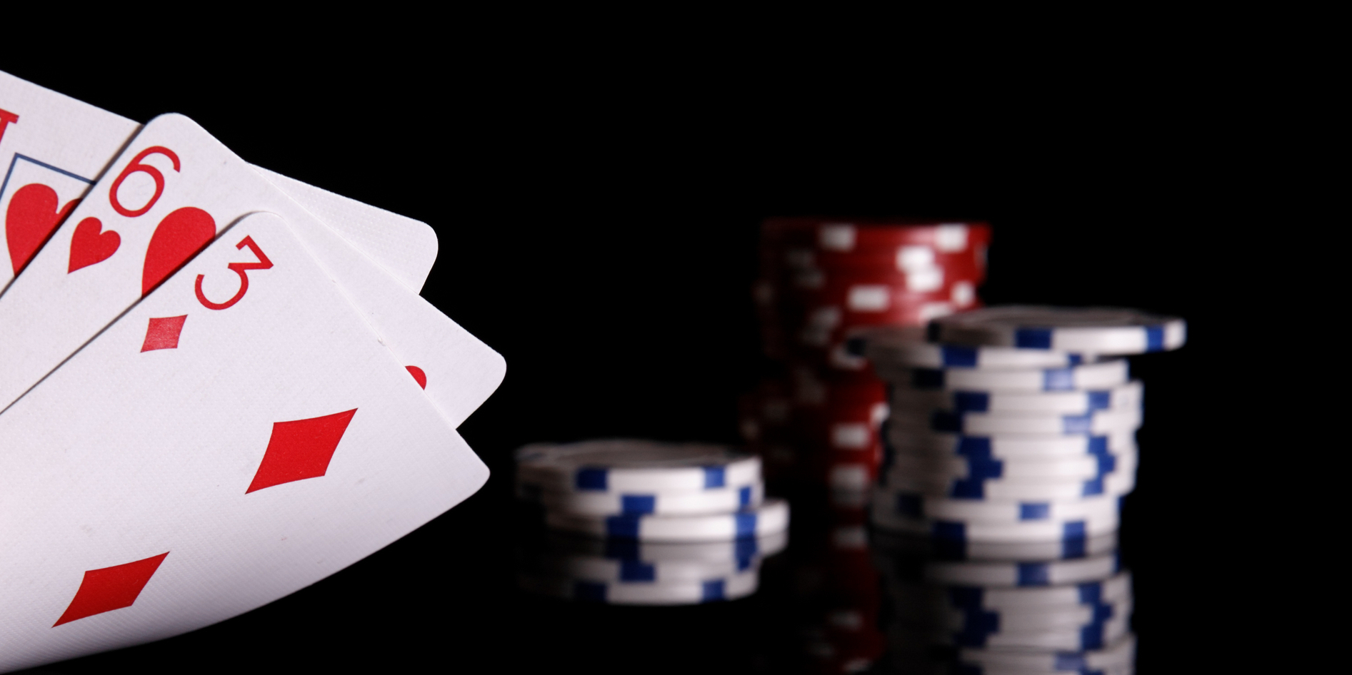 Close-up of playing cards and poker chips.