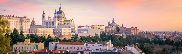 Wide angle of the Almudena Cathedral and Royal Palace in Madrid, Spain at sunset.