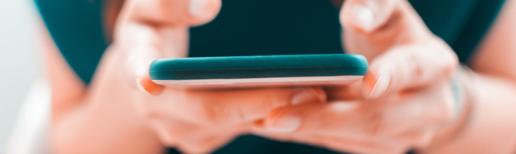 A close-up view of a young woman using her smartphone