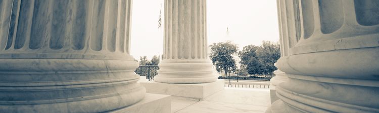 Close-up of architectural detail on base of columns at the United States Supreme Court building in Washington, DC.