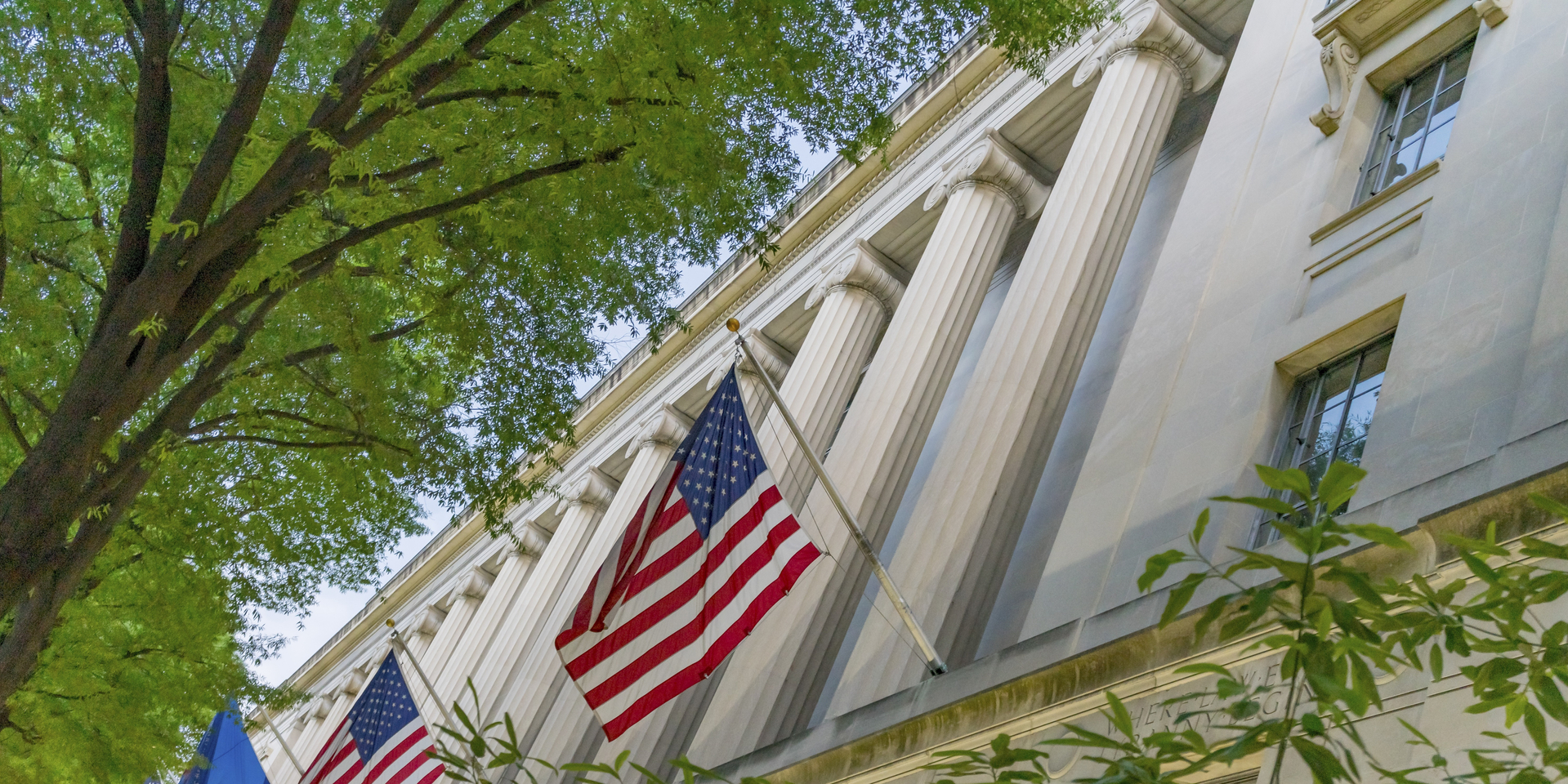 Facade Flags Justice Department Building Pennsylvania Avenue Washington DC Completed in 1935. Houses 1000s of lawyers working at Justice.