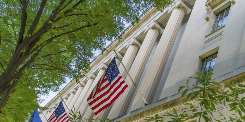 Facade Flags Justice Department Building Pennsylvania Avenue Washington DC Completed in 1935. Houses 1000s of lawyers working at Justice.
