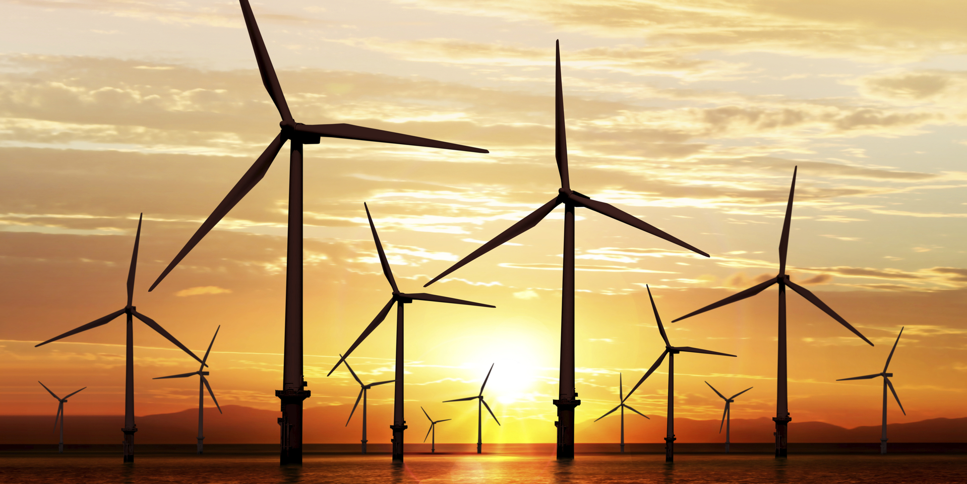silhouette of wind turbine generating electricity on sunset