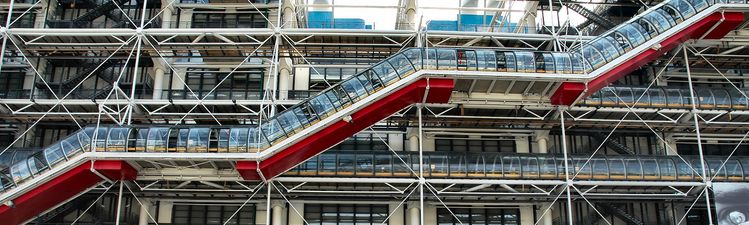 Wide angle of scaffolding outside of building with exterior escalator or stairs.