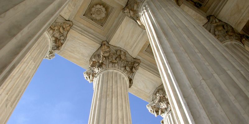 Up angle of Corinthian columns at the United States Spreme Court building in Washington, DC.