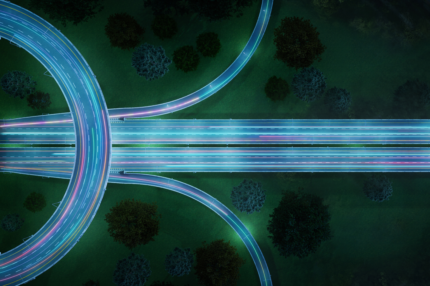 High angle down of light trails on freeway or highway system at night.