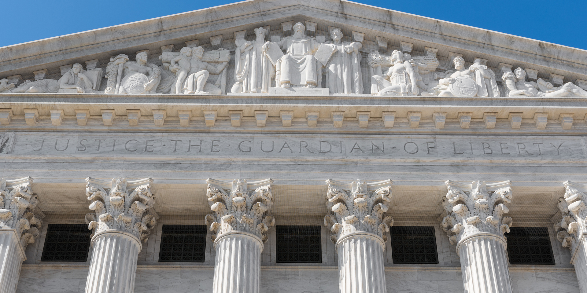 Exterior of Supreme Court of the United States on First Street in Washington DC, USA with legend 'Justice The Guardian of Liberty'