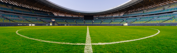 Wide angle of open-air soccer stadium.