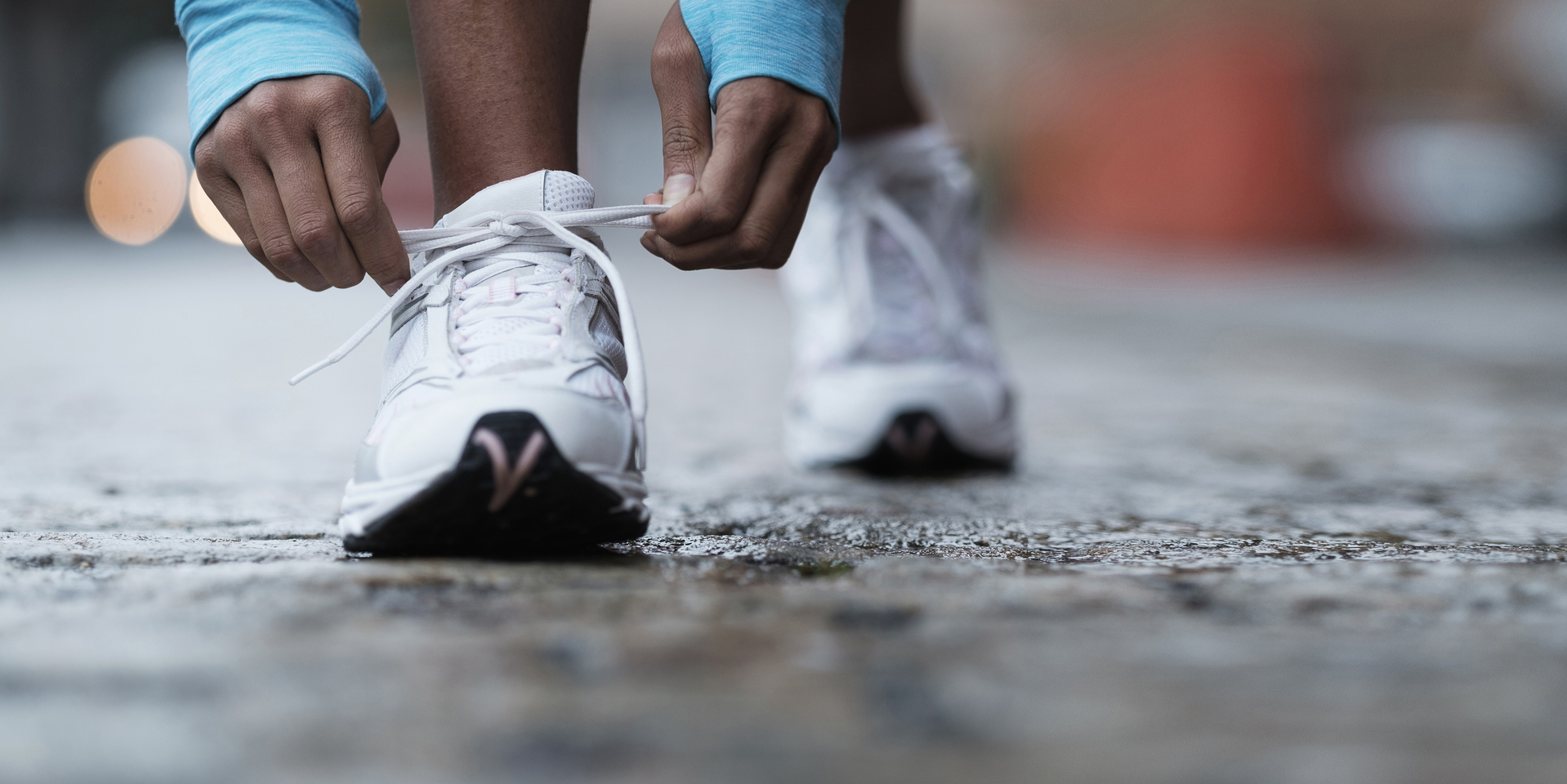 Mixed race runner tying shoelaces