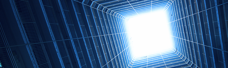 Square building in blue tone with sky in background.