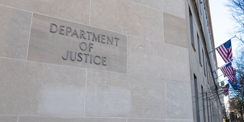 Close-up of sign for the Department of Justice (DOJ) on the Robert F. Kennedy Building.