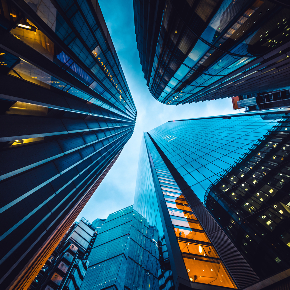 Looking directly up at the skyline of the financial district in central London