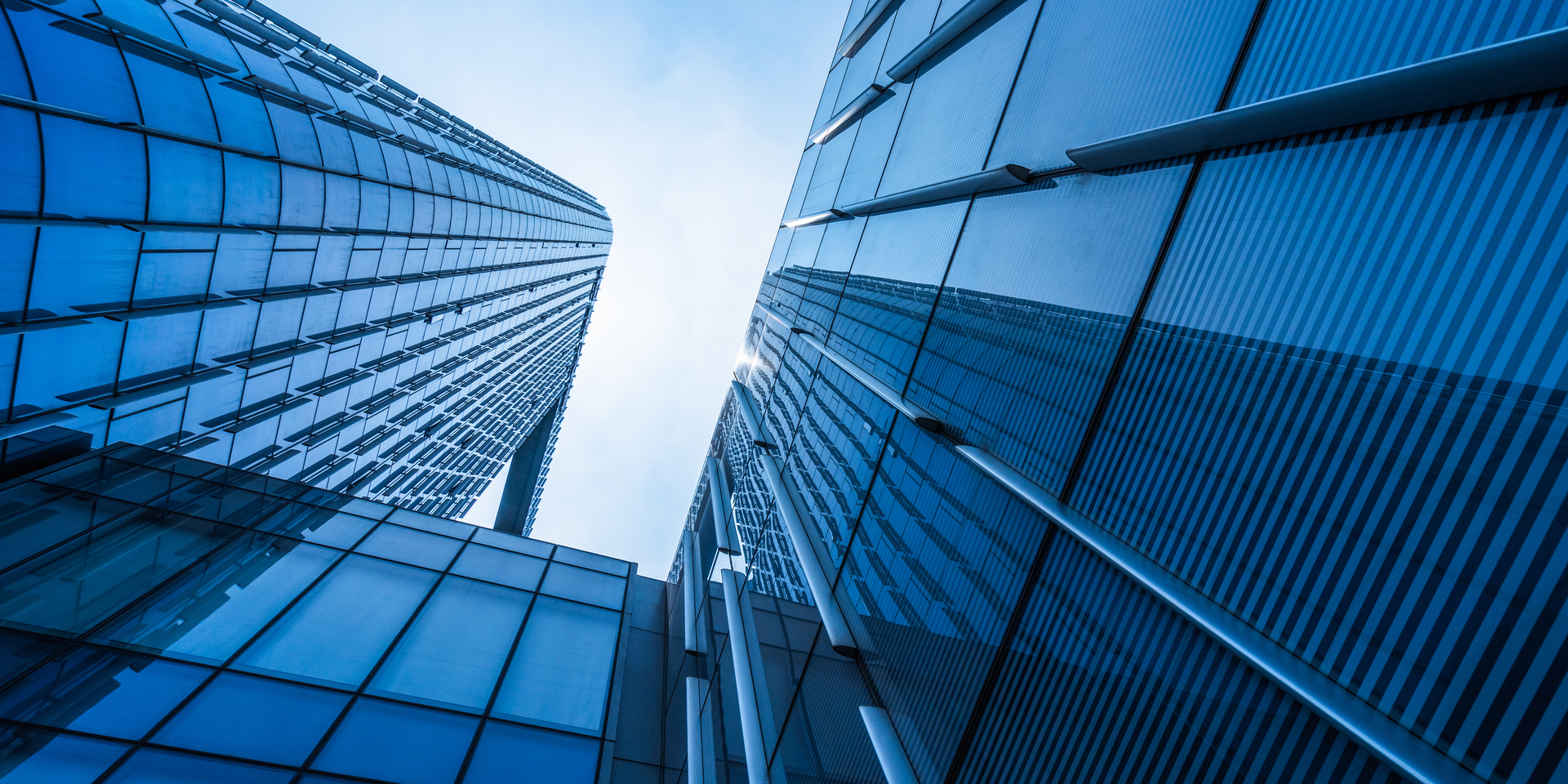 Up angle multi-story glass office building.