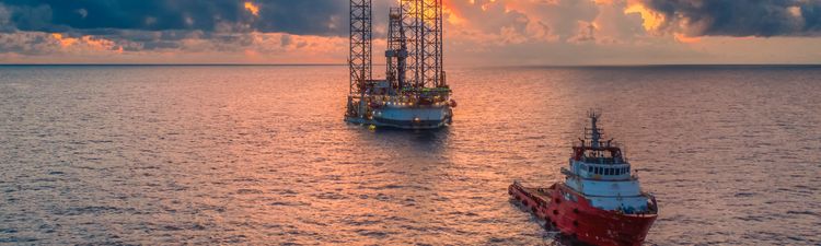 Wide angle of an offshore oil platform at sunset. 