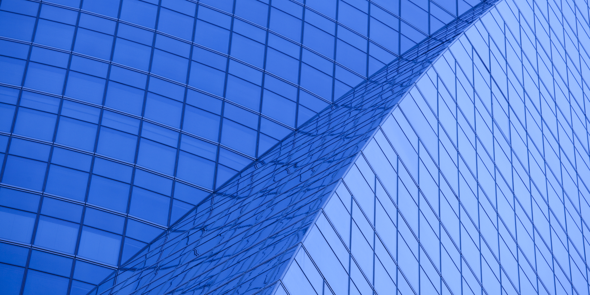 Close angle of curved architecture on glass buildling.