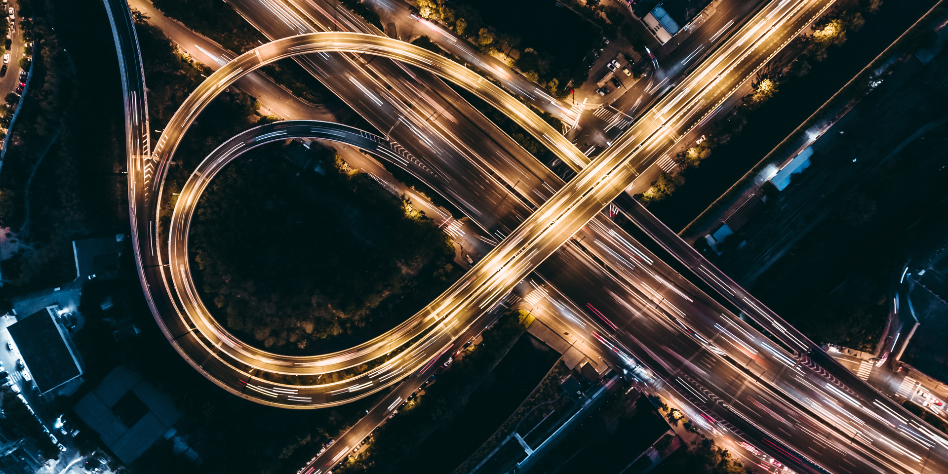 High angle down of circular freeway ramps at night. 