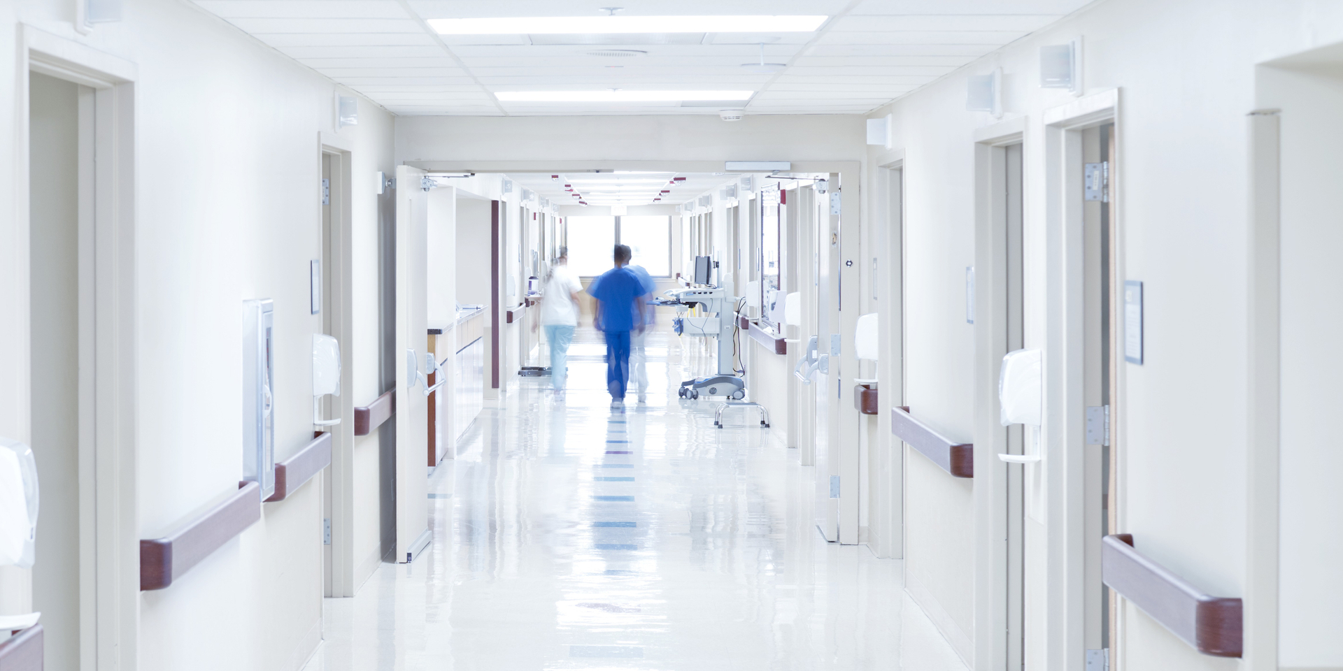 Doctor walking down hospital corridor.