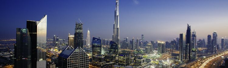 Wide angle of Dubai skyline with Sheikh Zayed Road traffic junction and Burj Khalifa visible.