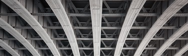 Medium angle of iron or steel beams under a bridge deck.