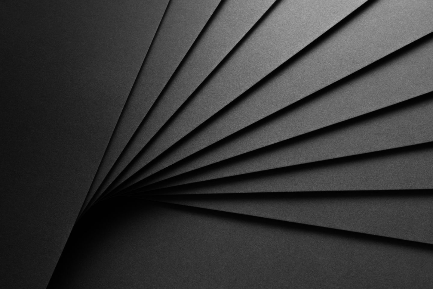 Close-up of fanned out black layered paper.