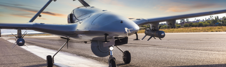 Medium angle of armed, unmanned aerial vehicle on runway.