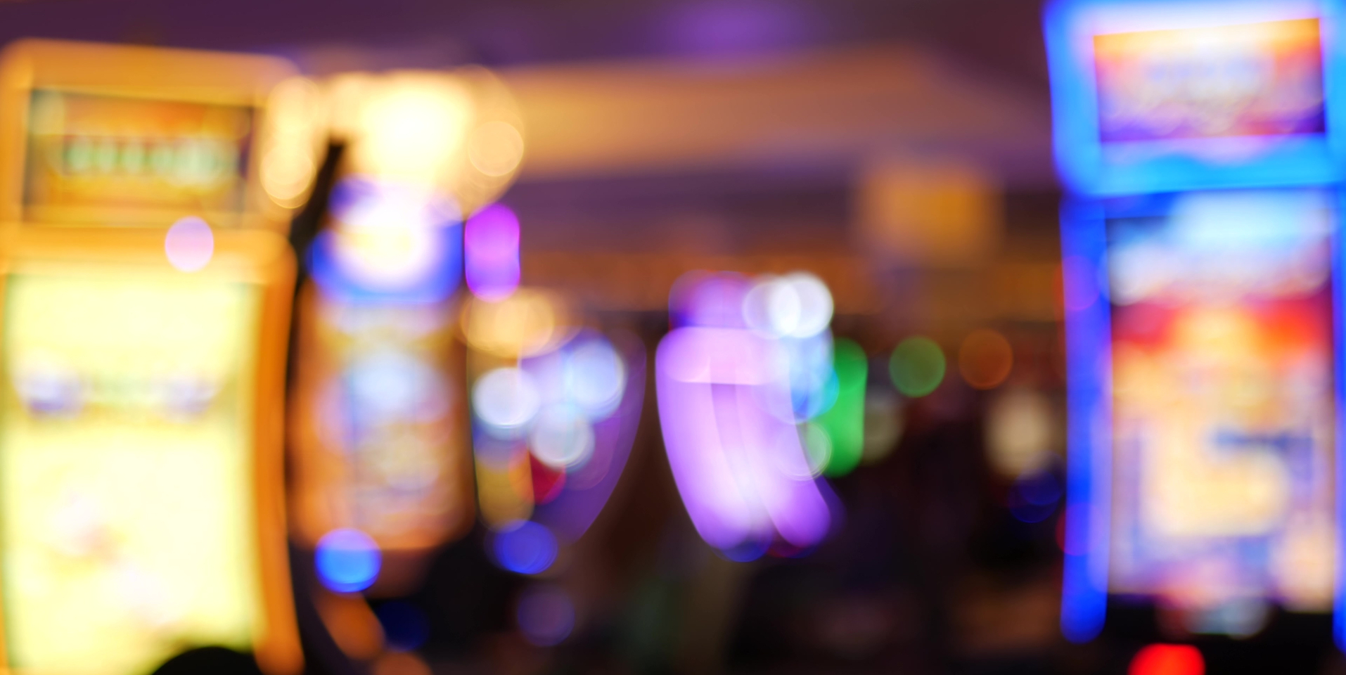 Medium angle blurred focus of slot machines in casino.