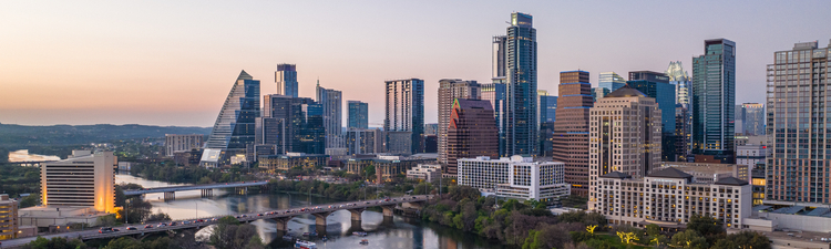 Wide angle of Austin, Texas skyline at dusk.