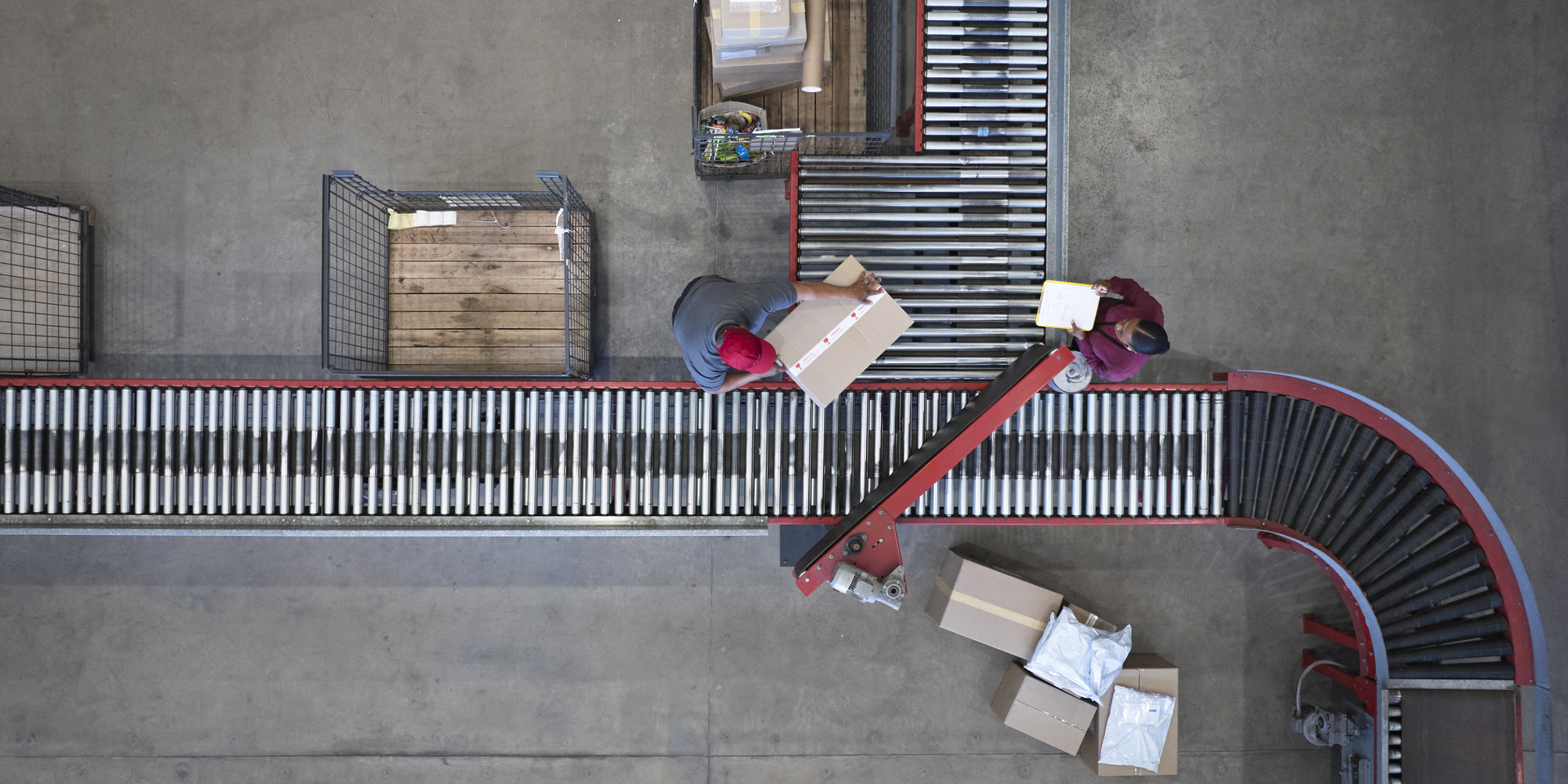 High angle down over conveyor belt in processing warehouse.