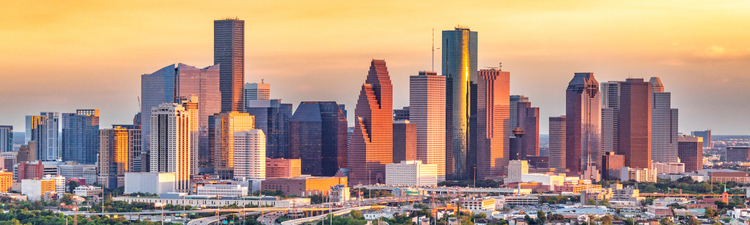 Aerial of Houston, Texas city skyline at sunset.