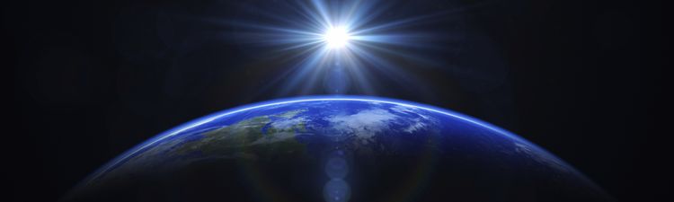 Medium angle digital rendering of sun rising beyond planet Earth.