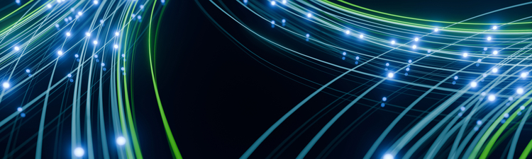 Medium angle of green and blue glowing light paths on black background with glowing points of contact.