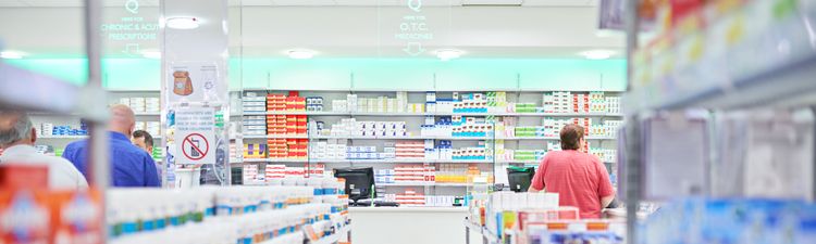 Medium angle of customers waiting in lines at pharmaceutical counter.