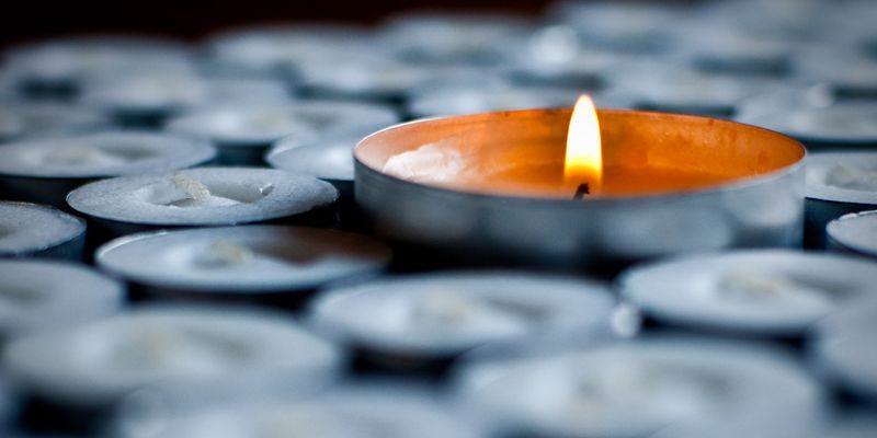 Close-up of lit tea light candle.