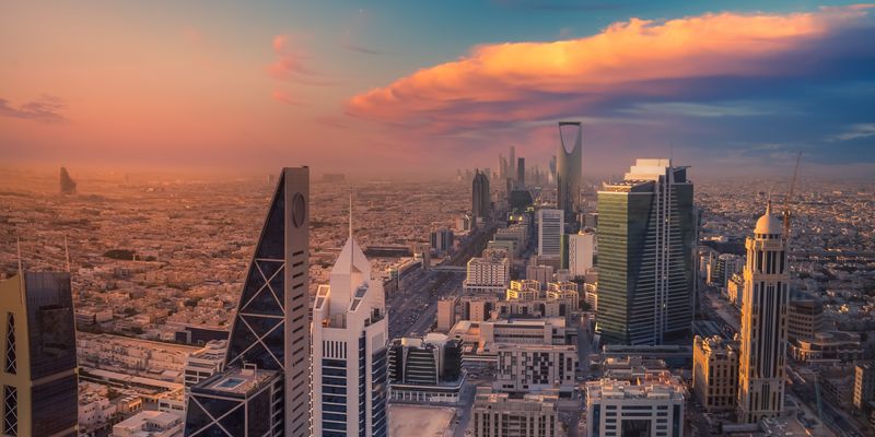 Wide angle of Riyadh skyline at sunset.