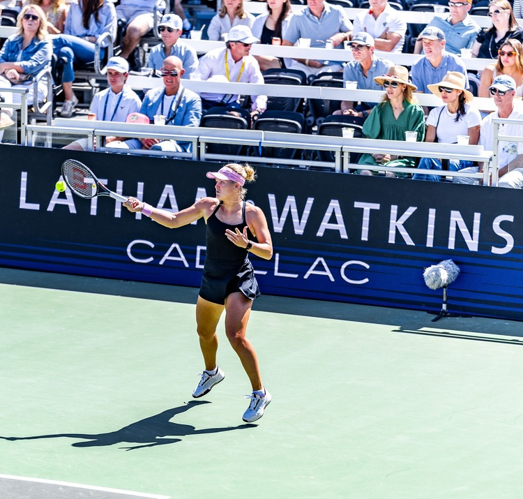 Tennis pro Peyton Stearns with Latham and Watkins banner branding at ATX Open 2026.