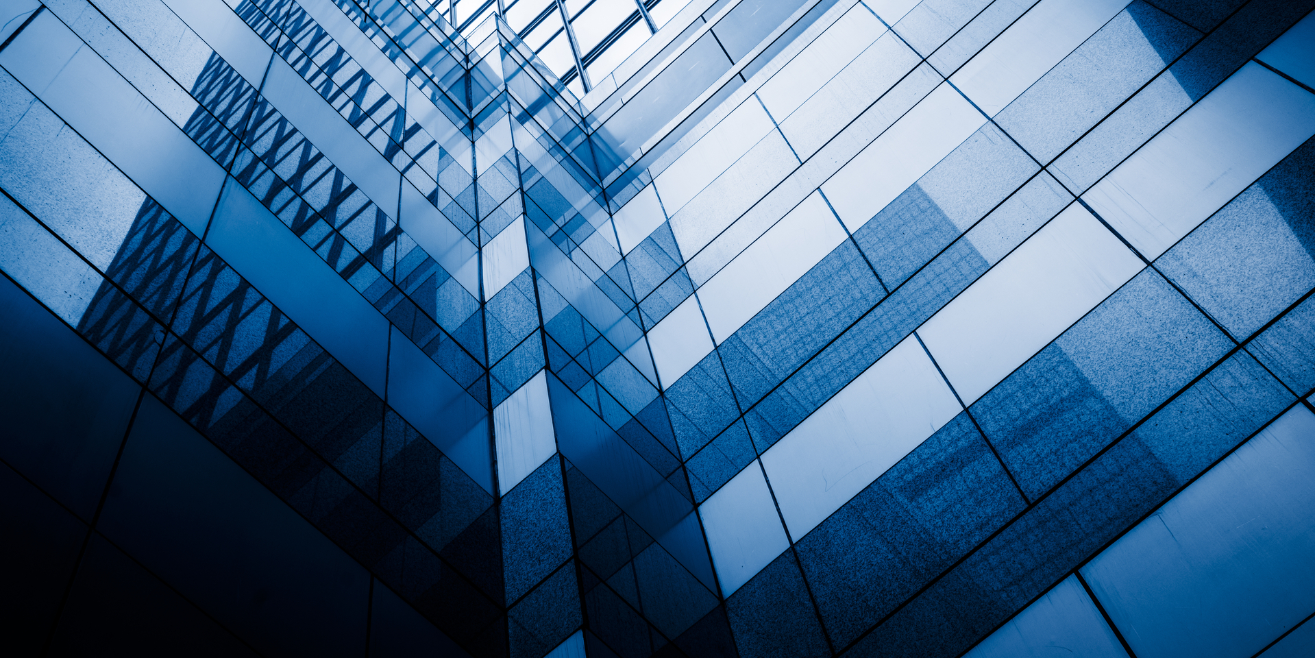 Perspective and underside angle view of contemporary glass building skyscraper,blue toned,china.