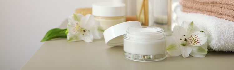 skincare cream and flowers on the table. Cosmetics for skin care.