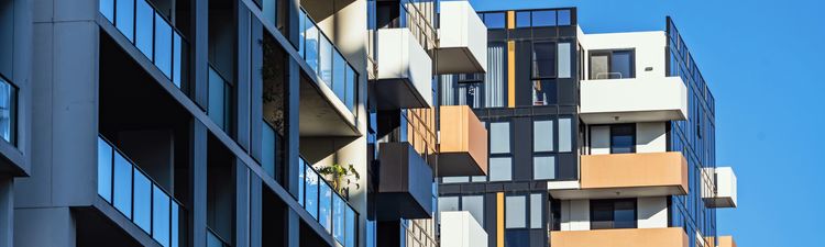 Medium angle of high-rise apartment building with balconies.