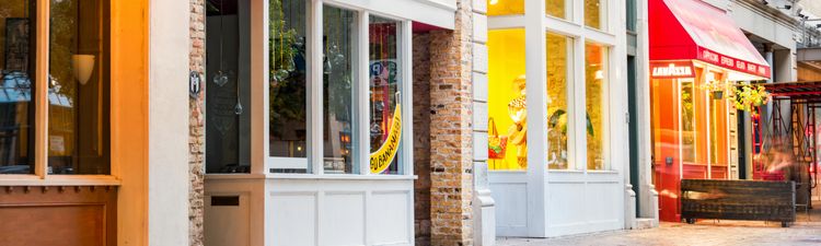 Wide angle of storefront windows on main street shopping district.