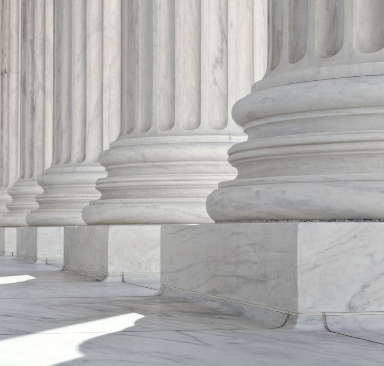 Close-up of architectural detail on base of columns at the United States Supreme Court building in Washington, DC.