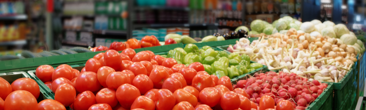 Medium angle of vegetables in plastic crates at a supermarket.