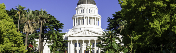 California State Capitol Building with red roses in the foreground in Sacramento, CA, USA