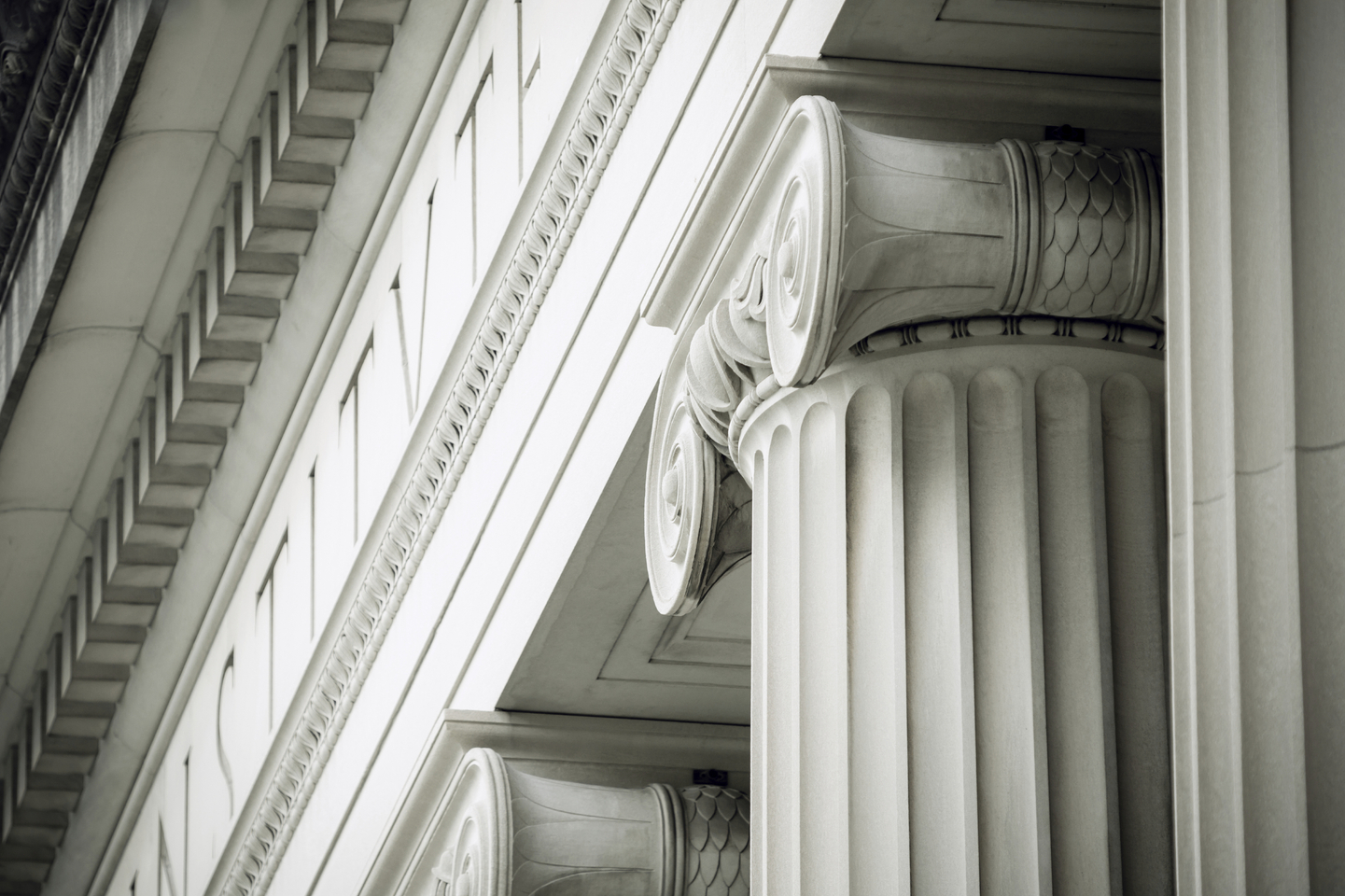 Close-up on Ionic columns of a courthouse.