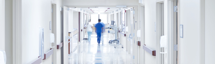 Doctor walking down hospital corridor.