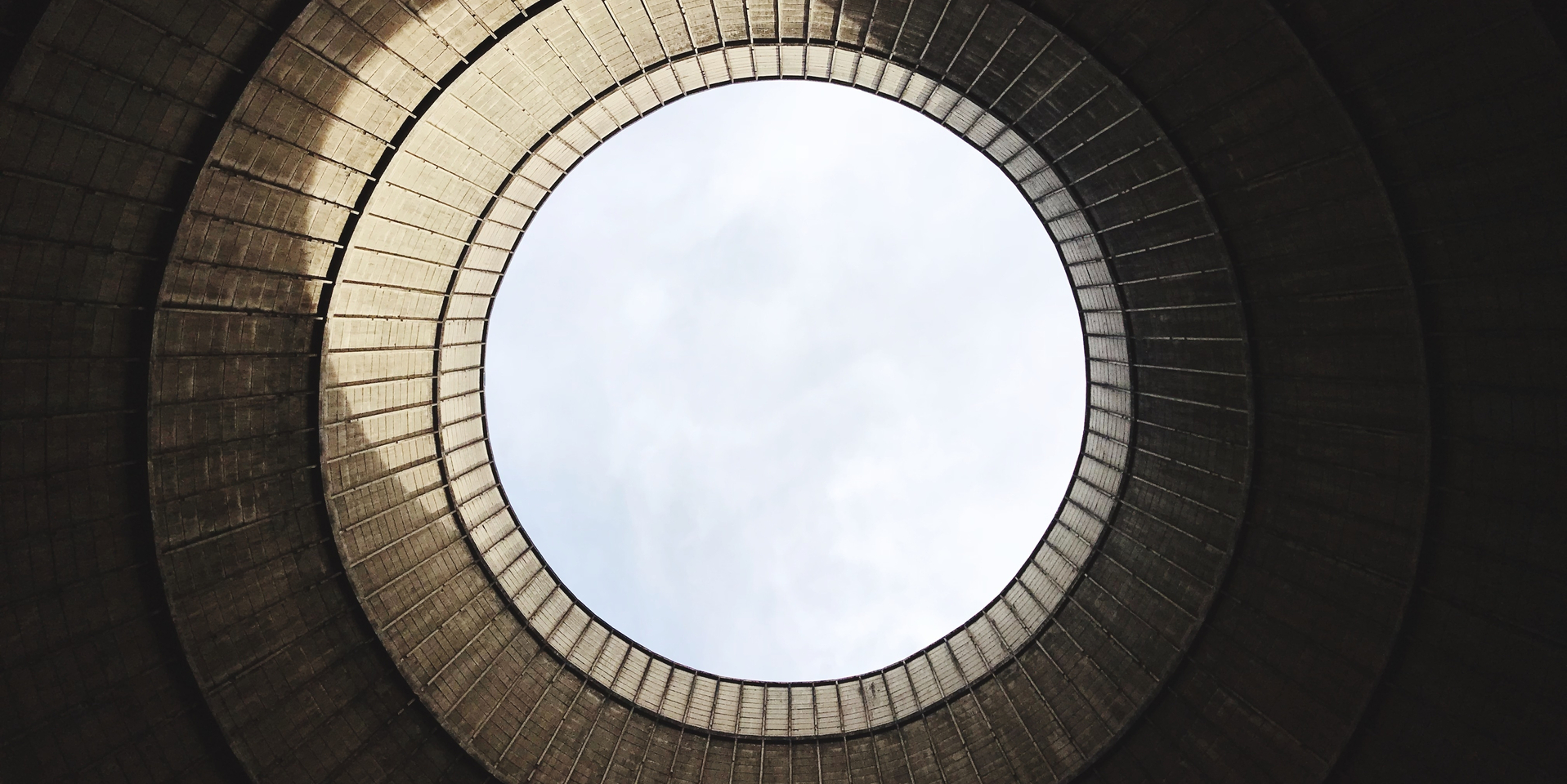 Low Angle View Of Cooling Tower Of Nuclear Power Plant Against Sky