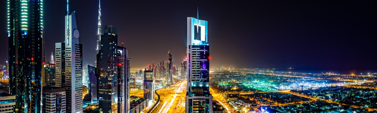 Modern Dubai cityscape along E11 Sheikh Zayed Road highway, Dubai, United Arab Emirates at twilight.